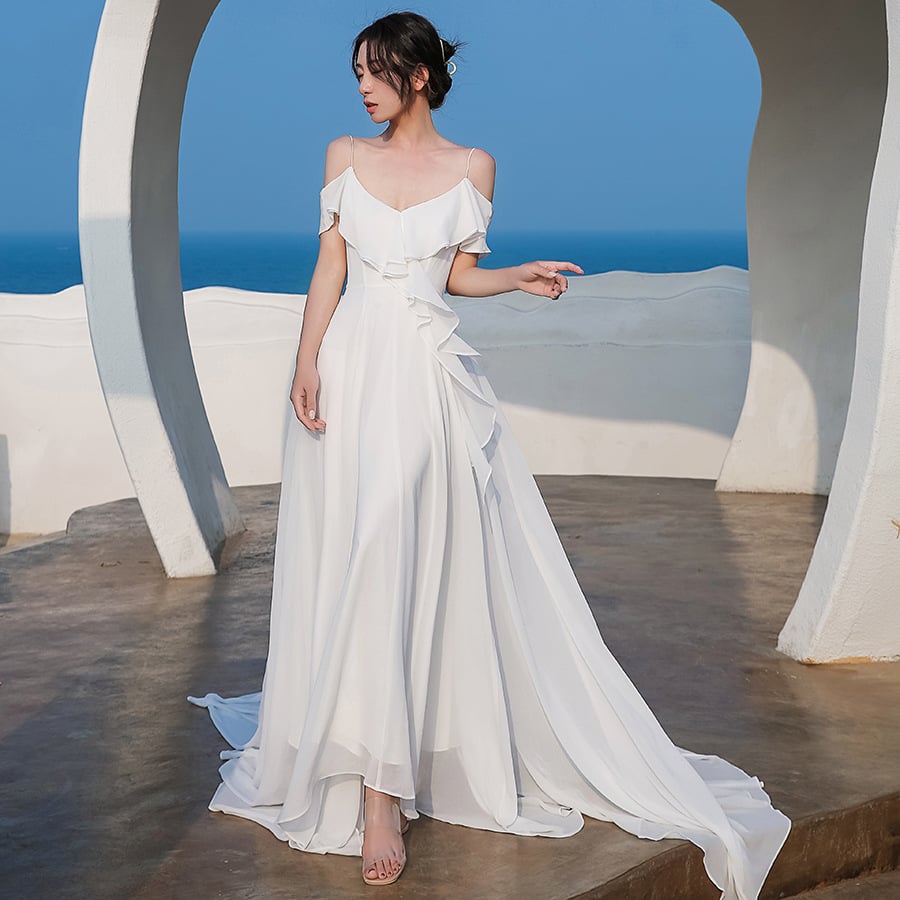 Elegant women's white chiffon dress by Ramshackle Shack, flowing fabric with a stylish neckline, perfect for formal occasions.