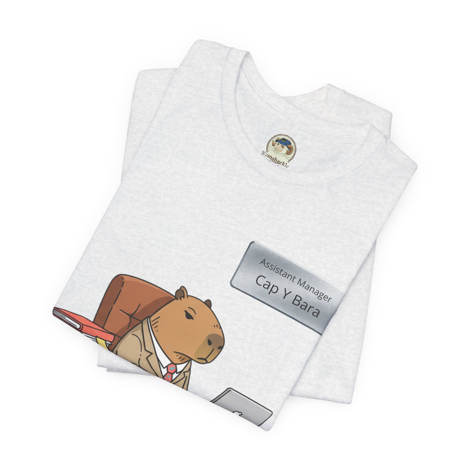 Capybara in suit desk tee featuring "Stuck on Repeat" personalized nameplate, casual graphic T-shirt by Printify.