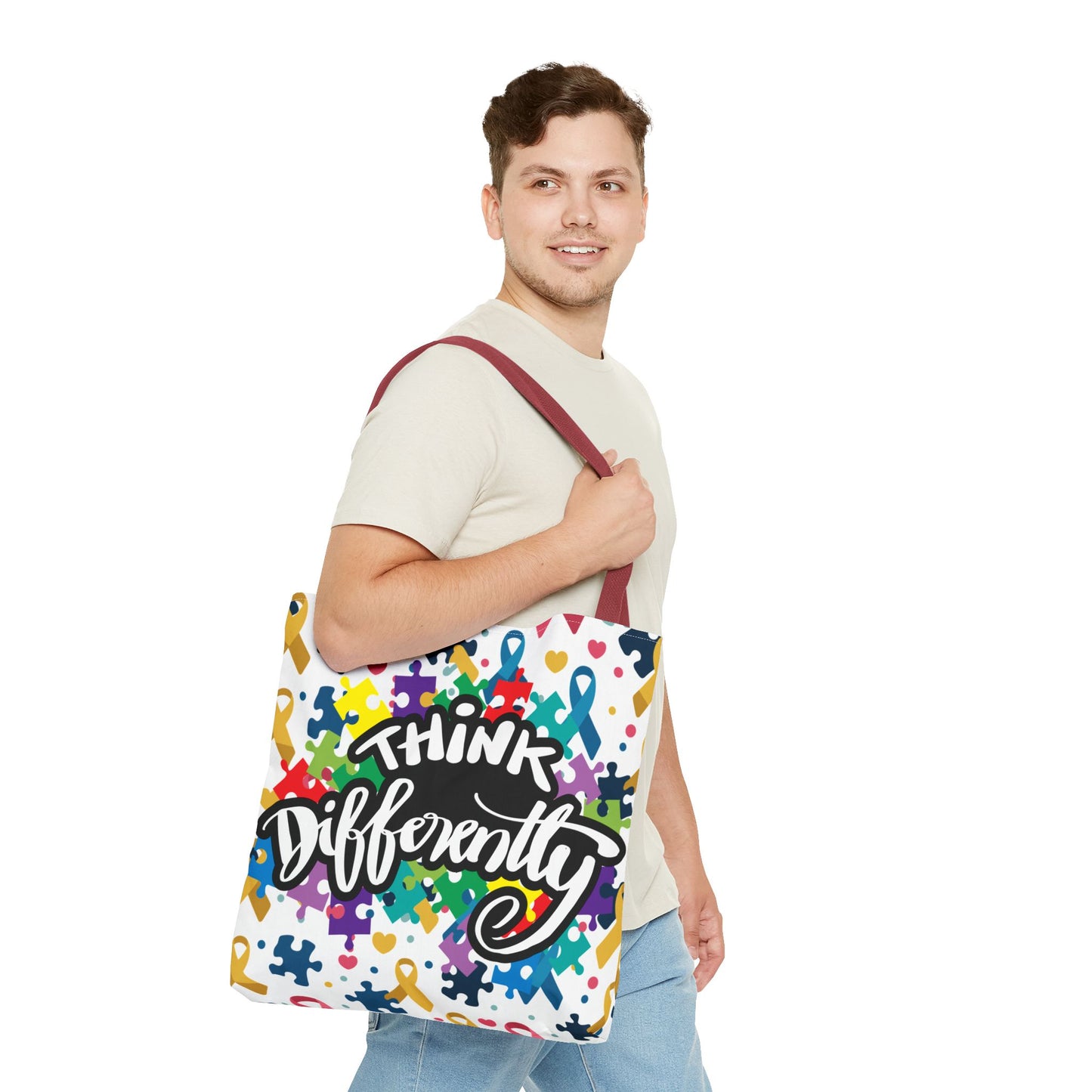 Colorful puzzle ribbon design on a Think Differently Autism Awareness Tote Bag by Printify, showcasing vibrant patterns.