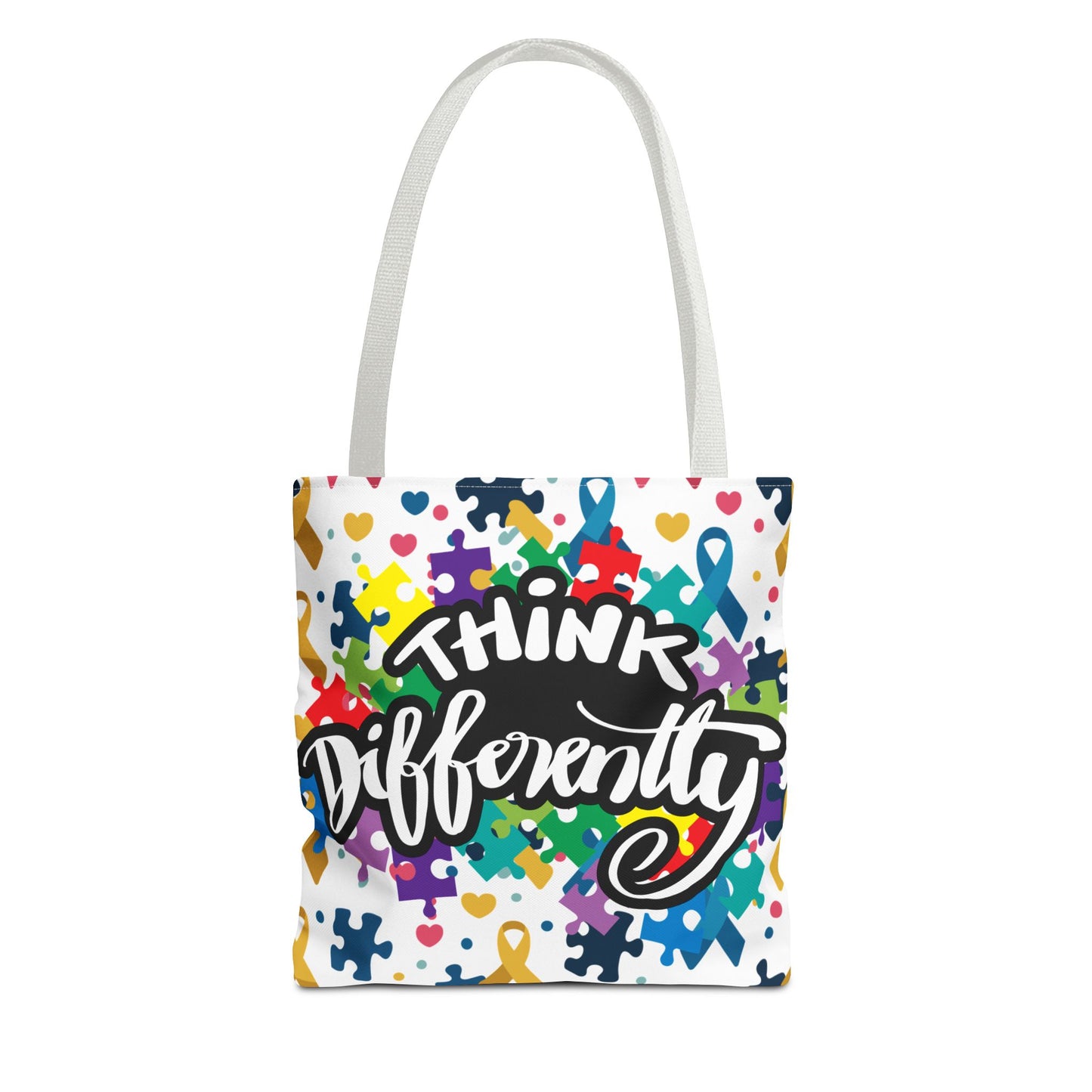 Colorful puzzle ribbon design on Think Differently Autism Awareness tote bag by Printify, perfect for carrying essentials.