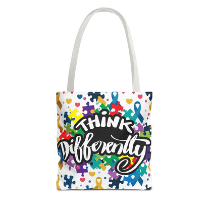 Colorful puzzle ribbon design on Think Differently Autism Awareness tote bag by Printify, perfect for carrying essentials.