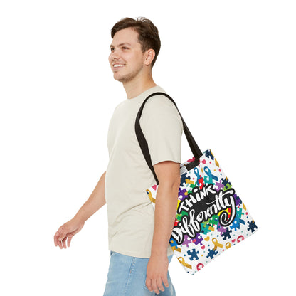 Colorful puzzle ribbon design on Think Differently Autism Awareness tote bag by Printify, showcasing vibrant art and spacious design.