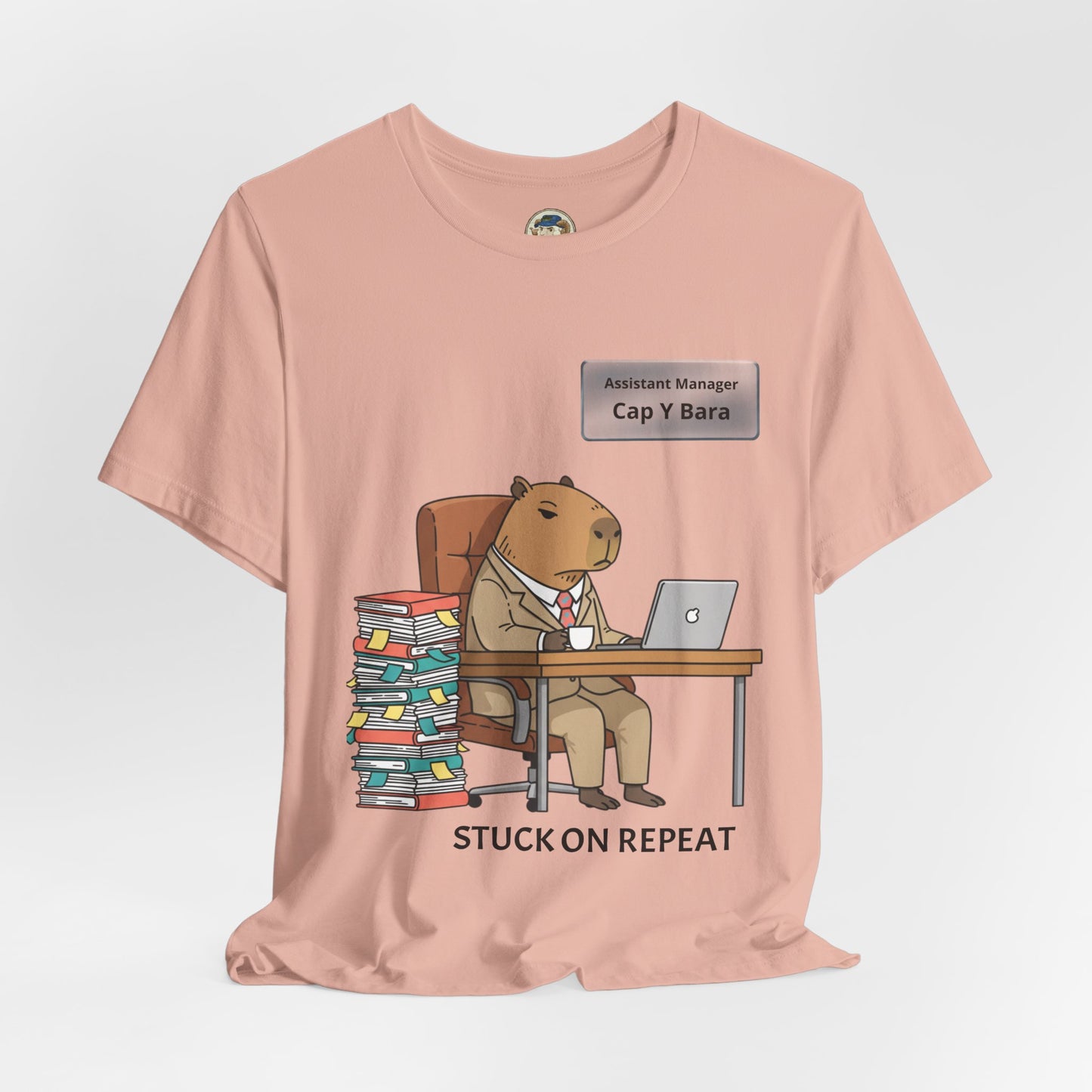 Capybara in suit desk tee featuring "Stuck on Repeat" personalized nameplate design, casual printify t-shirt on a white background.