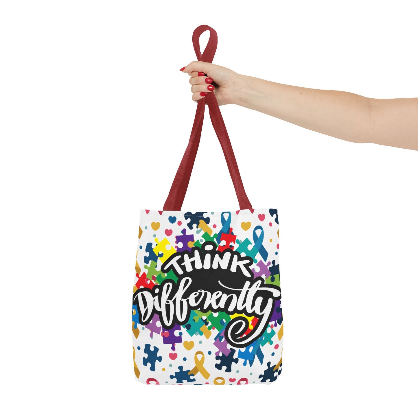Colorful puzzle ribbon design on Think Differently Autism Awareness tote bag by Printify, showcasing vibrant patterns.