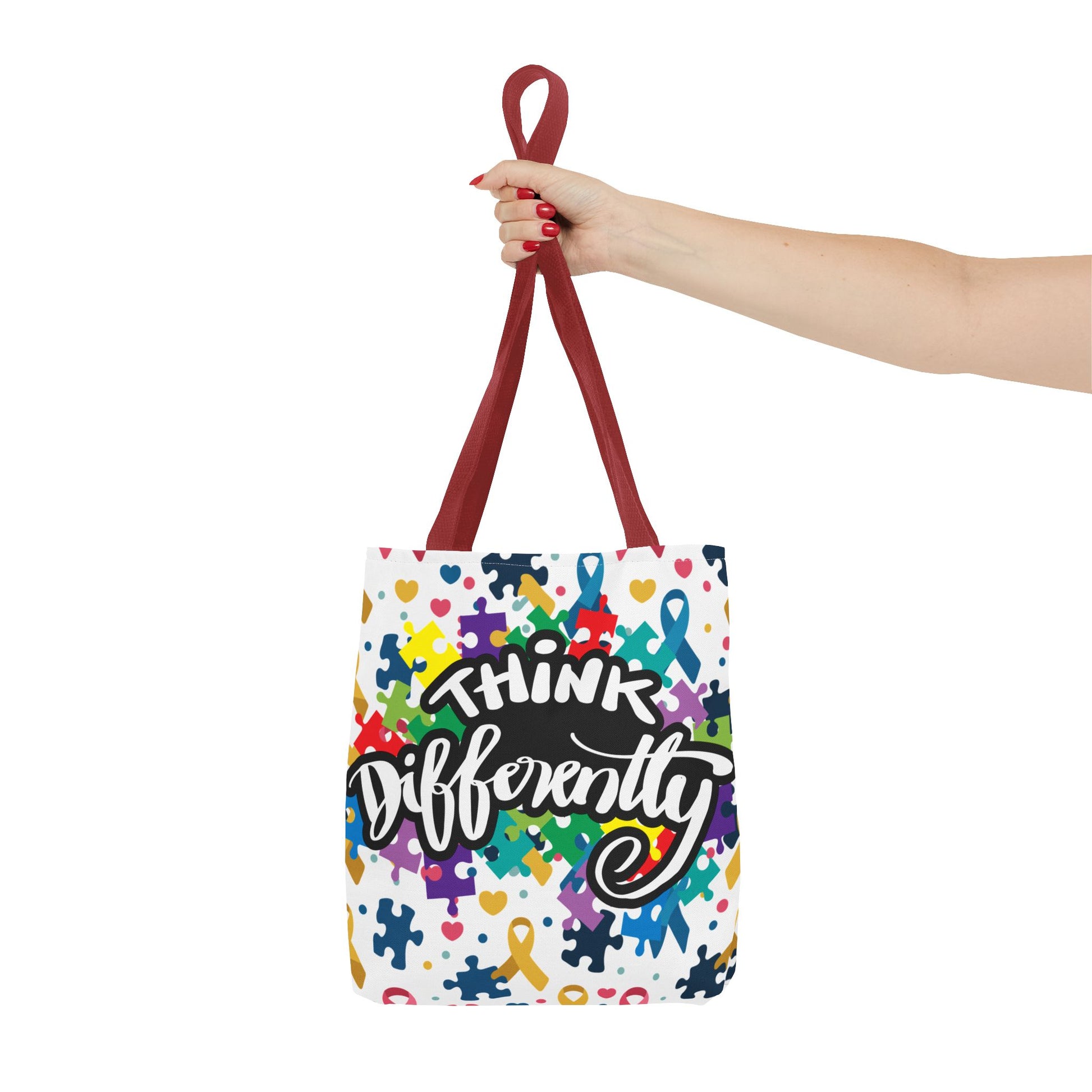Colorful puzzle ribbon design on Think Differently Autism Awareness tote bag by Printify, showcasing vibrant patterns.
