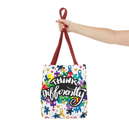 Colorful puzzle ribbon design on Think Differently Autism Awareness tote bag by Printify, showcasing vibrant patterns.