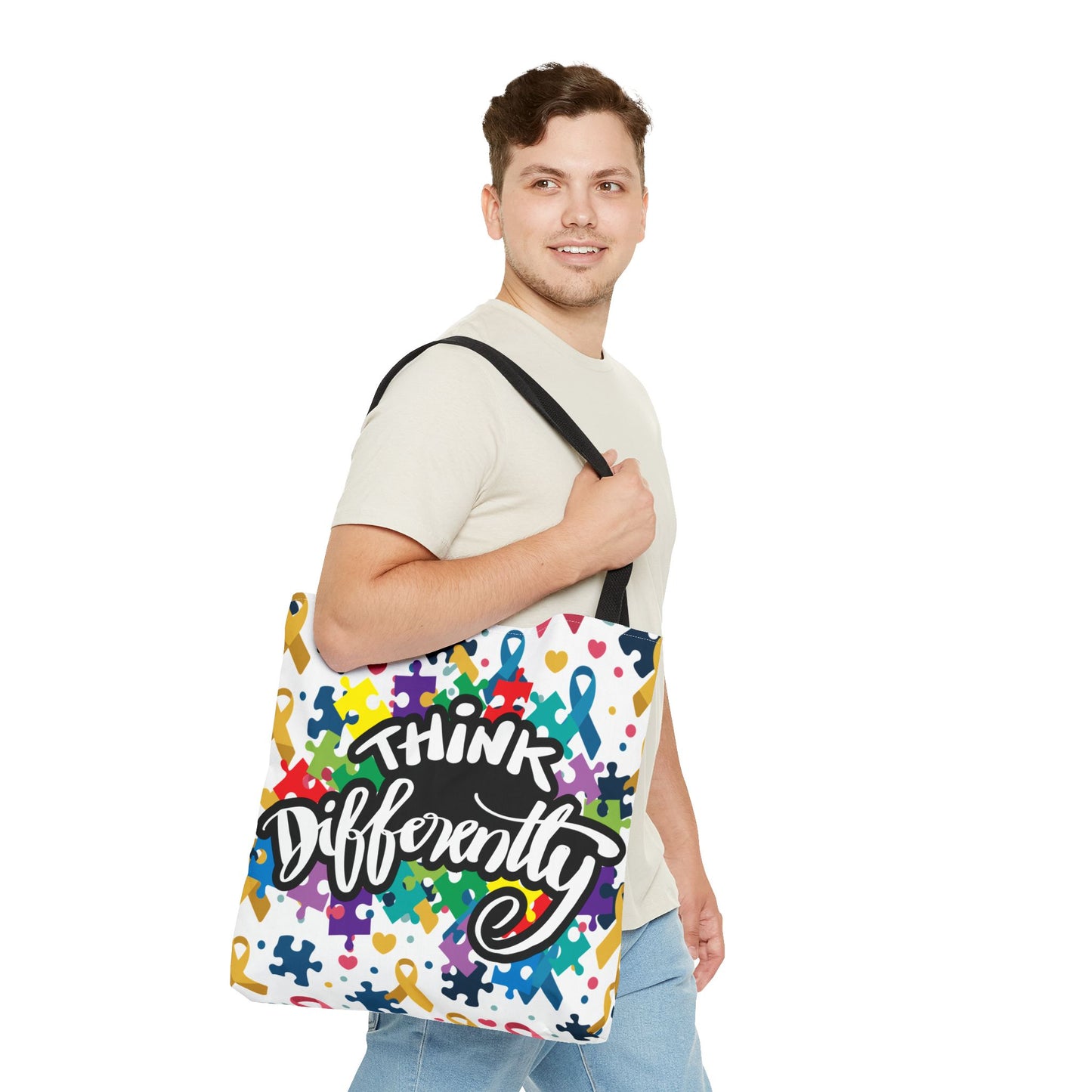 Colorful puzzle ribbon design on Think Differently Autism Awareness Tote Bag by Printify, showcasing vibrant art and spacious design.