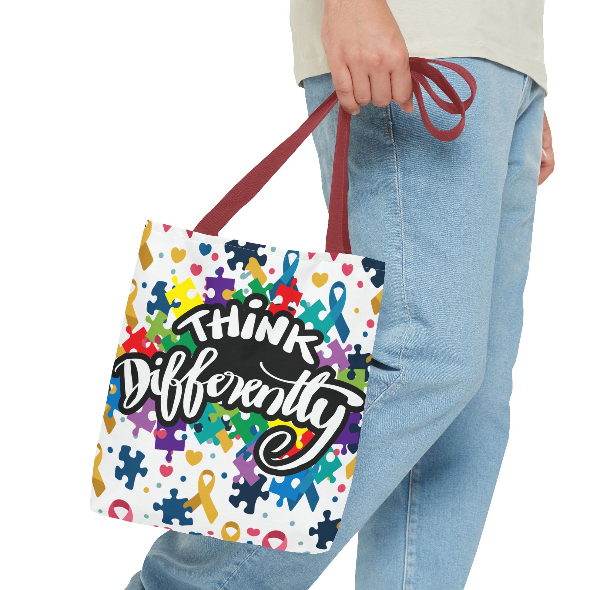Colorful puzzle ribbon design on Think Differently Autism Awareness tote bag by Printify, showcasing vibrant artwork.