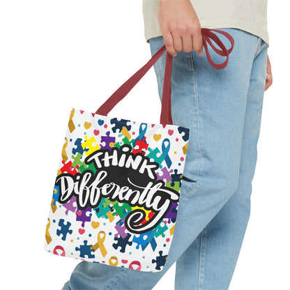 Colorful puzzle ribbon design on Think Differently Autism Awareness tote bag by Printify, showcasing vibrant artwork.