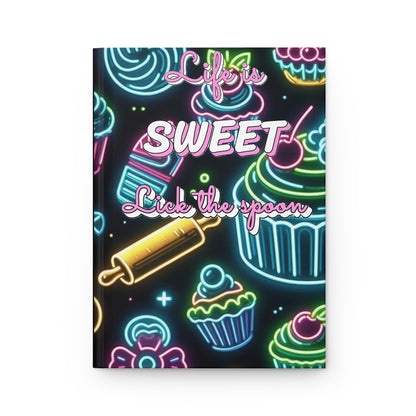 Neon hardcover journal with "Life is Sweet, Lick the Spoon" quote and colorful design, ideal for notes and journaling.