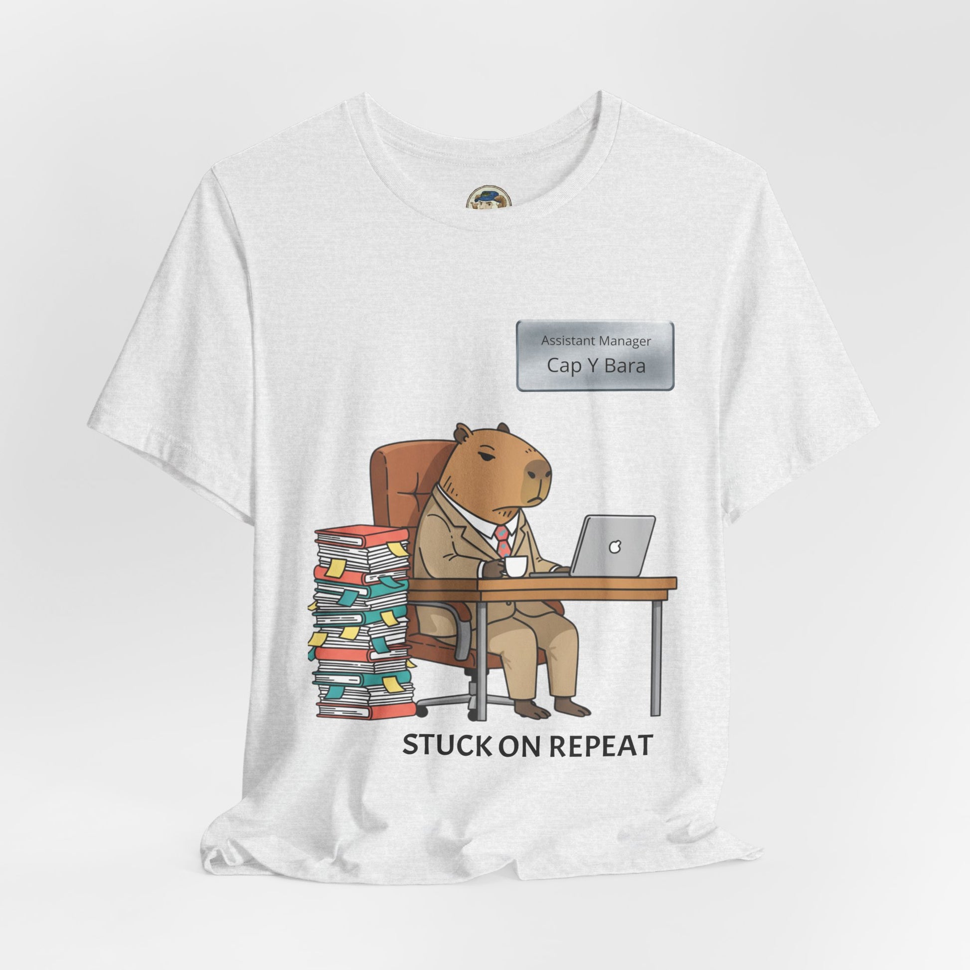Printify Capybara in Suit Desk Tee featuring "Stuck on Repeat" text and personalized nameplate design, casual graphic T-shirt.