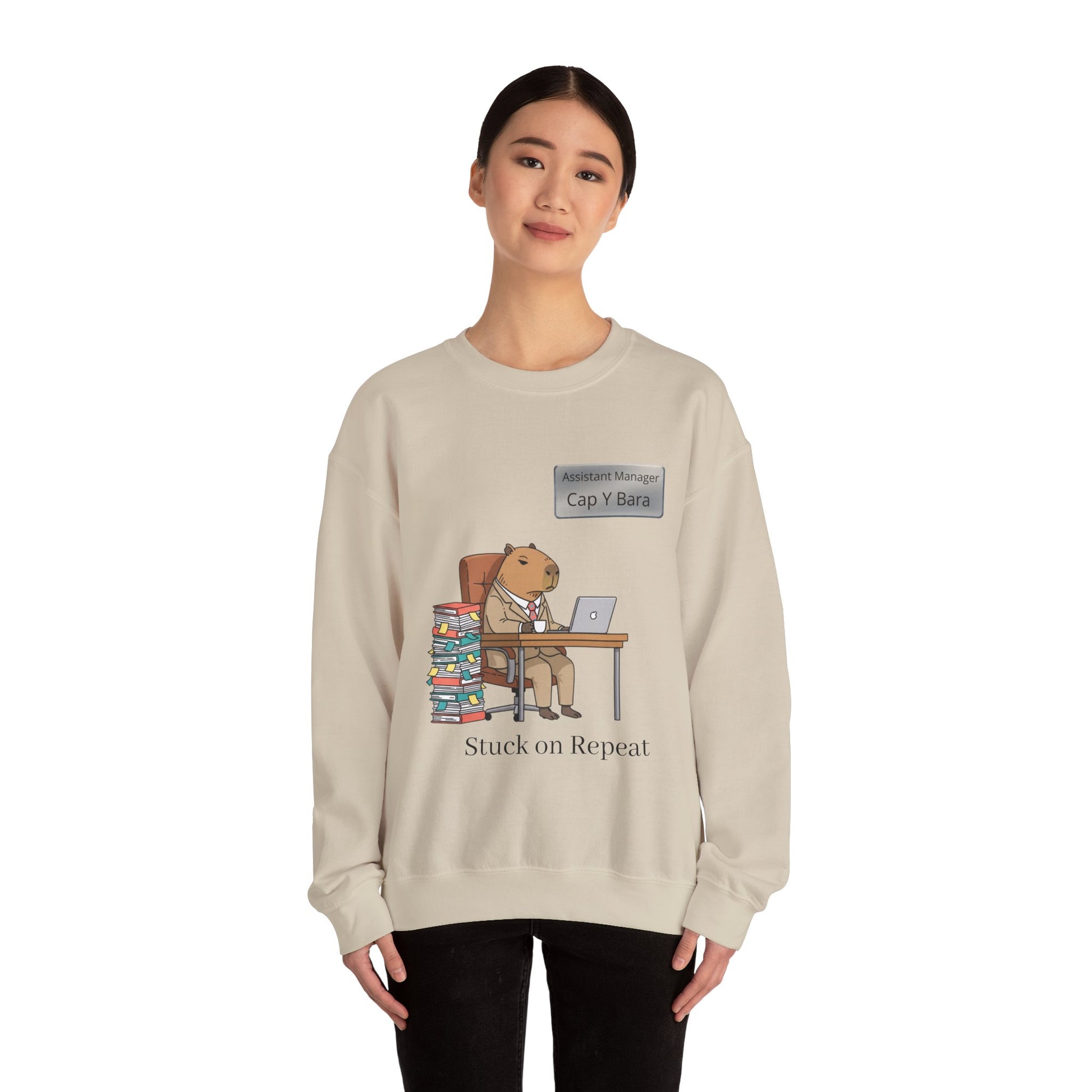 Gray sweatshirt featuring an illustration of an office-capable capybara at a desk representing unhinged animal bureaucracy.