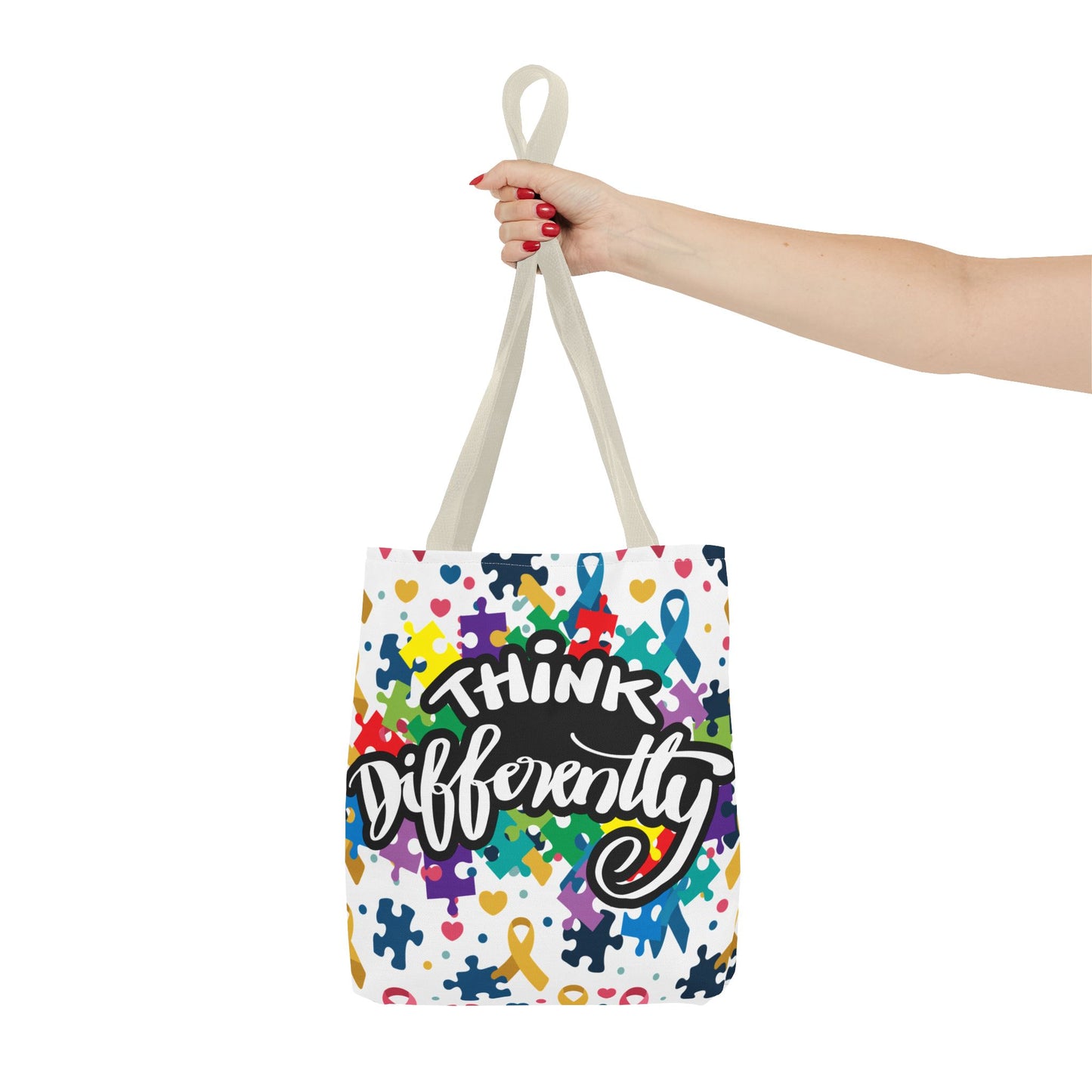 Colorful puzzle ribbon design on Think Differently Autism Awareness tote bag by Printify, showcasing vibrant, eye-catching patterns.