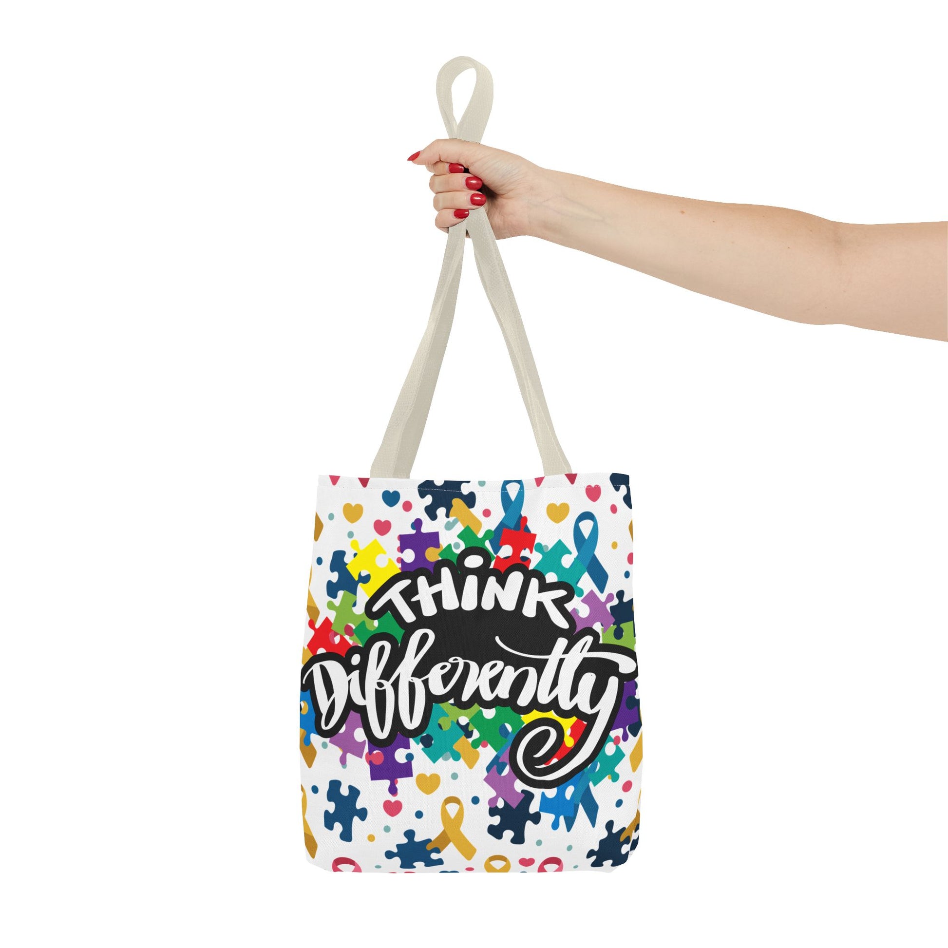 Colorful puzzle ribbon design on Think Differently Autism Awareness tote bag by Printify, showcasing vibrant, eye-catching patterns.