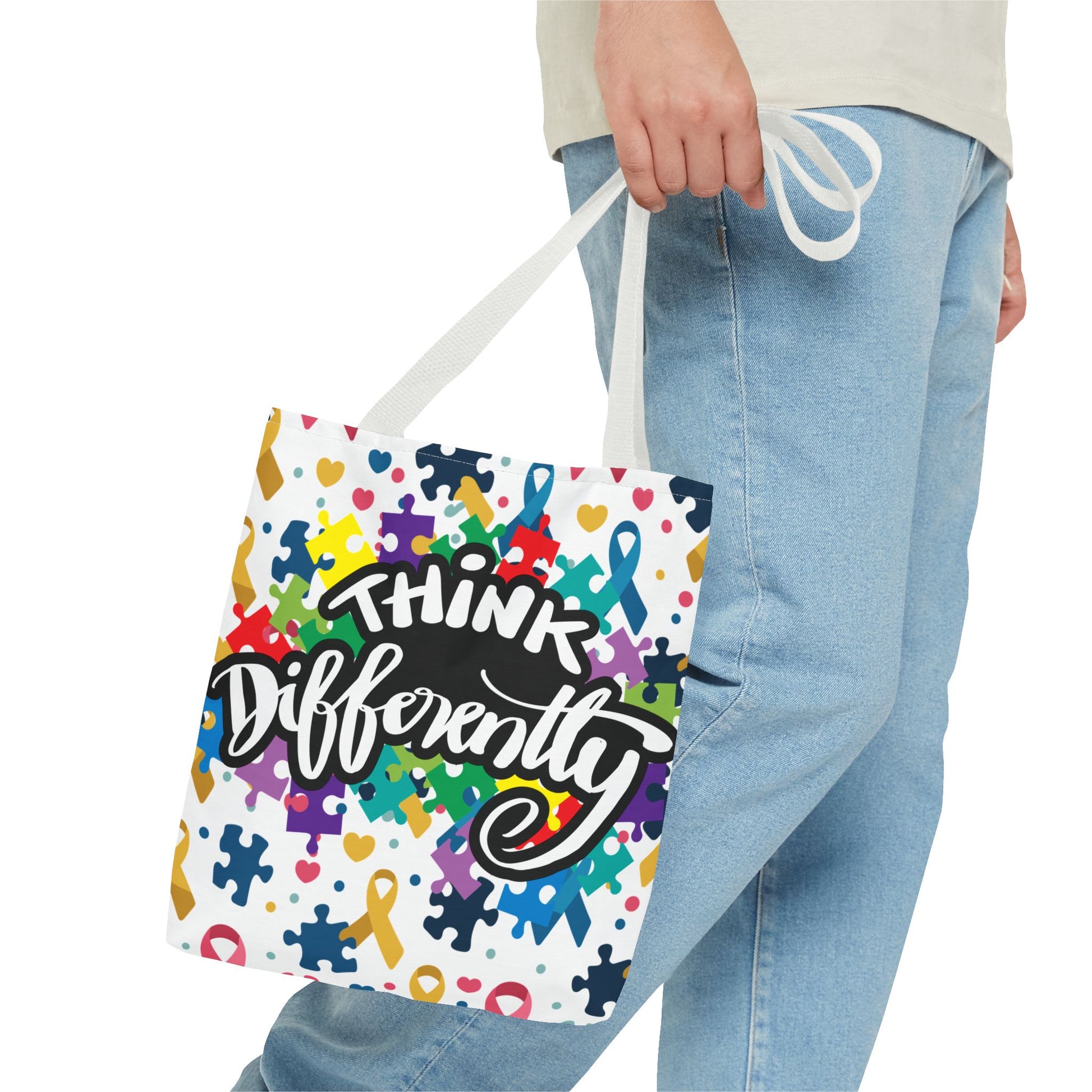 Colorful puzzle ribbon design on Think Differently Autism Awareness tote bag by Printify, showcasing vibrant colors and patterns.