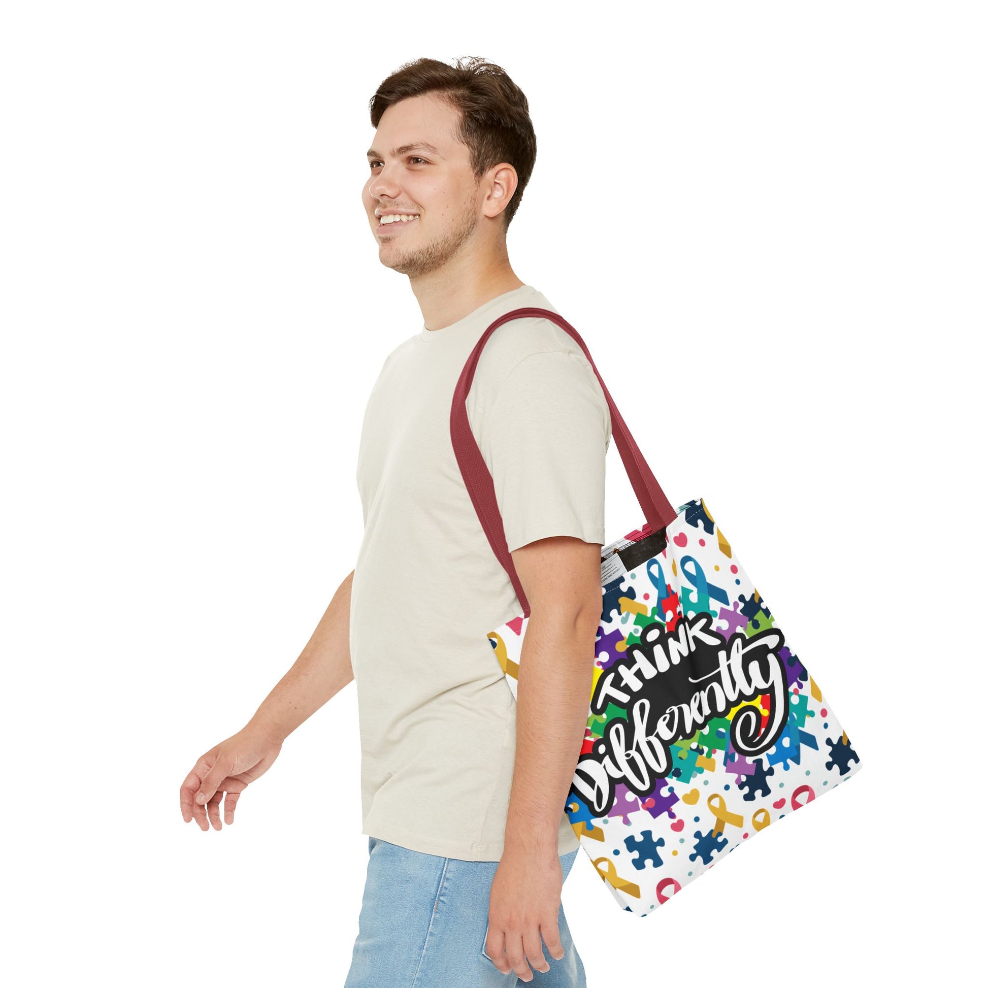 Colorful puzzle ribbon design on a Think Differently Autism Awareness tote bag by Printify.