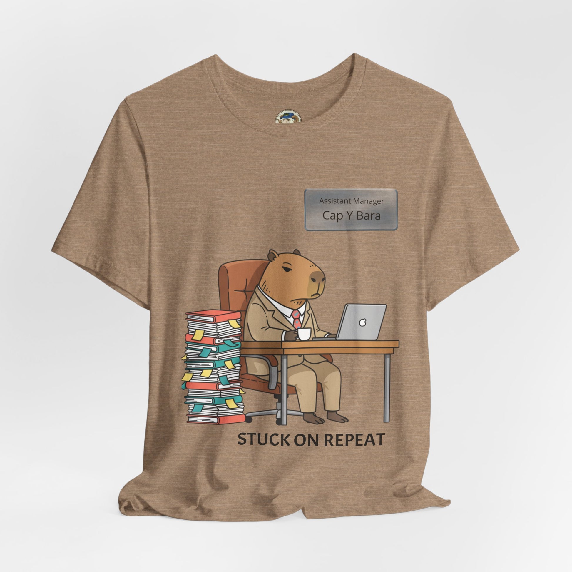 Printify Capybara in Suit Desk Tee featuring "Stuck on Repeat" design and personalized nameplate, casual graphic T-shirt for animal lovers.