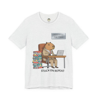 Gray T-shirt featuring a capybara in a suit with the text "Stuck on Repeat" and a personalized nameplate design.