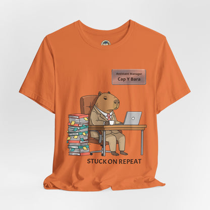 Printify "Stuck on Repeat" capybara in suit desk tee, personalized nameplate graphic on a casual T-shirt.