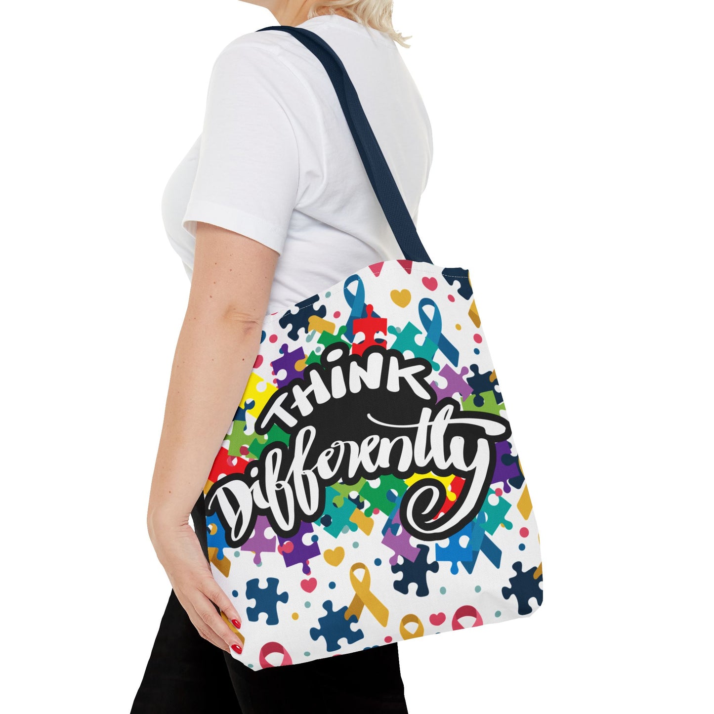 Colorful puzzle ribbon design on Think Differently Autism Awareness tote bag by Printify, showcasing vibrant patterns.