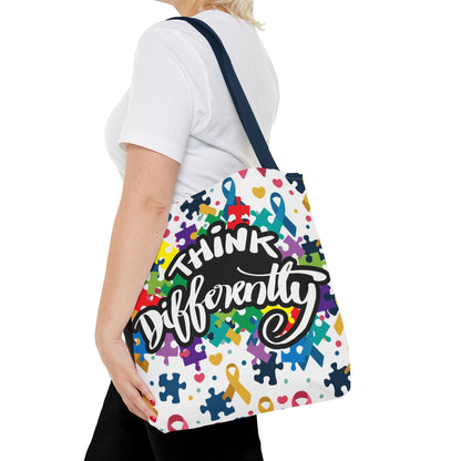 Colorful puzzle ribbon design on Think Differently Autism Awareness tote bag by Printify, showcasing vibrant patterns.