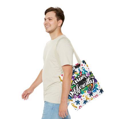 Colorful puzzle ribbon design on a Think Differently Autism Awareness tote bag by Printify.