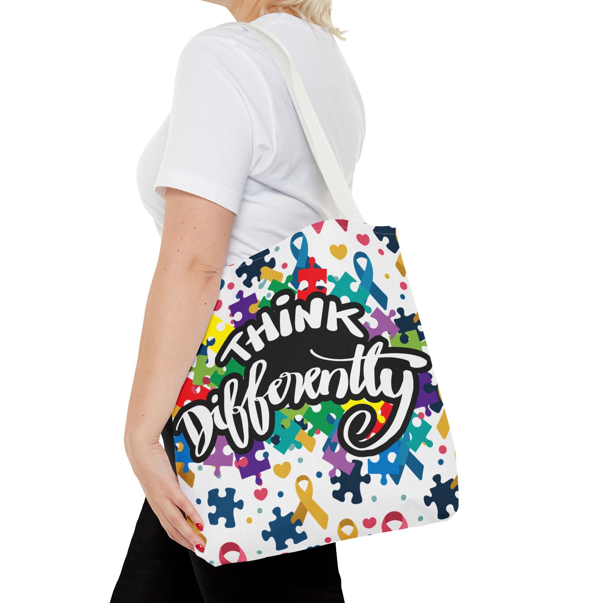 Colorful puzzle ribbon design on a Think Differently Autism Awareness tote bag by Printify, perfect for everyday use.