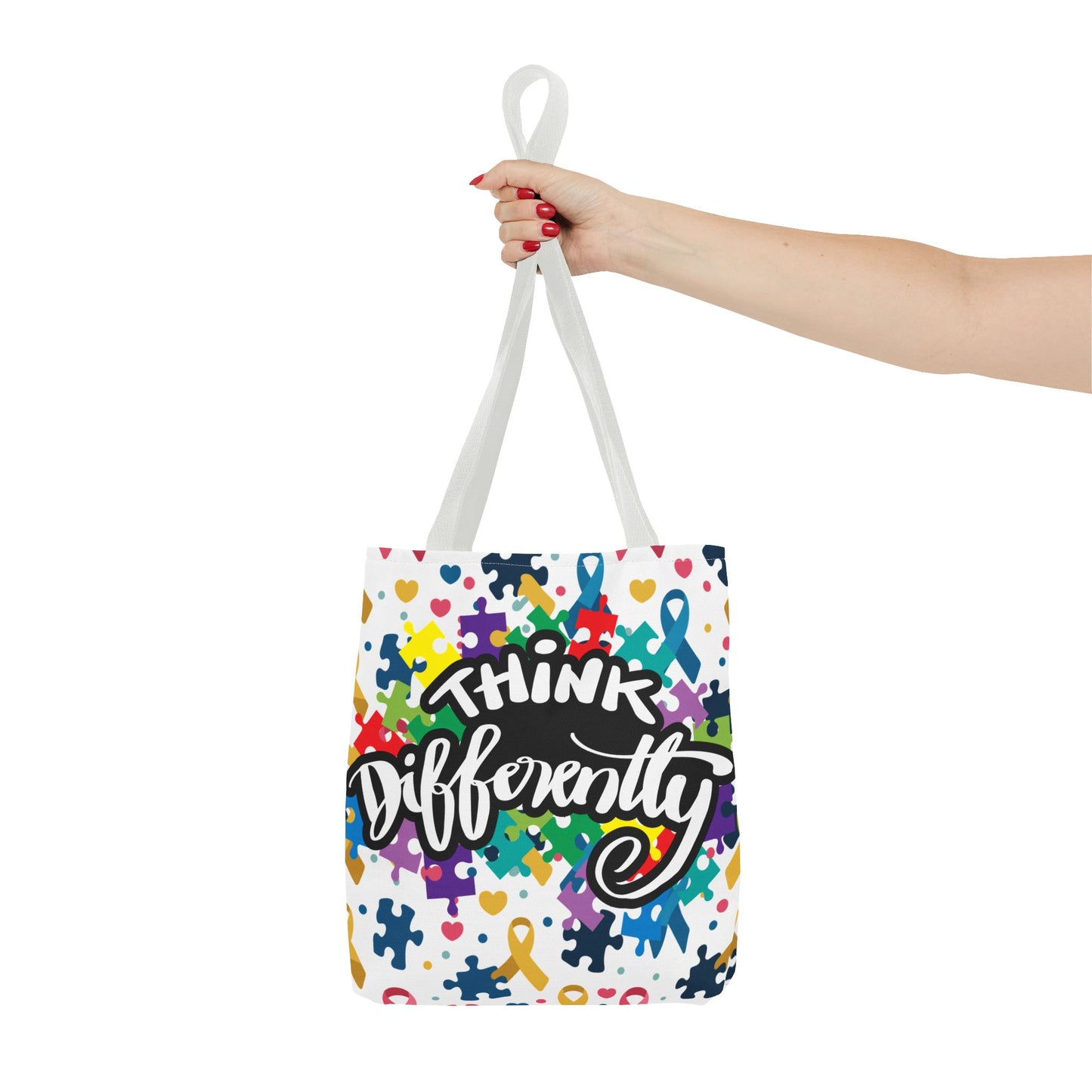 Colorful puzzle ribbon design on a Think Differently Autism Awareness tote bag by Printify, showcasing vibrant patterns.