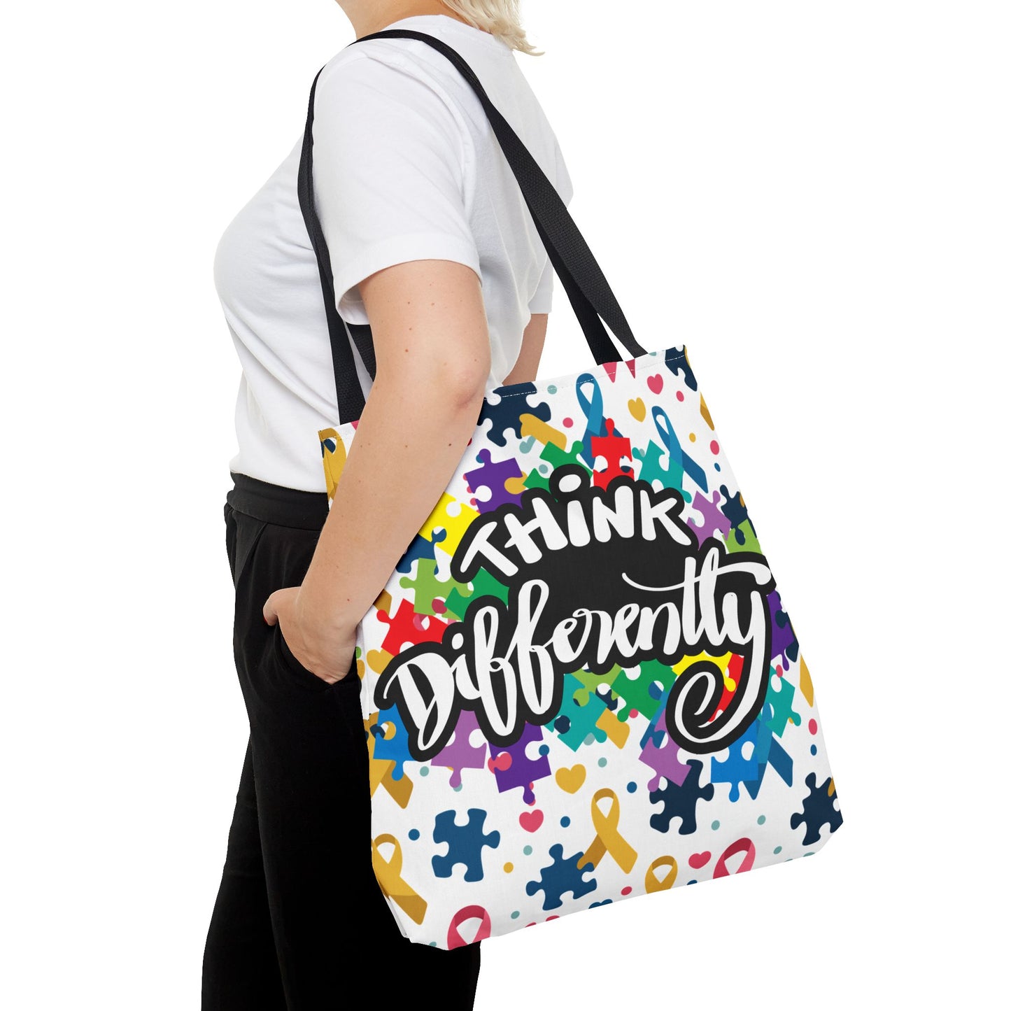 Colorful puzzle ribbon design on Think Differently Autism Awareness tote bag by Printify, showcasing vibrant colors and patterns.