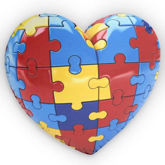 Colorful Autism Puzzle Heart Pillow by Printify, featuring vibrant puzzle pieces on a soft, plush fabric.