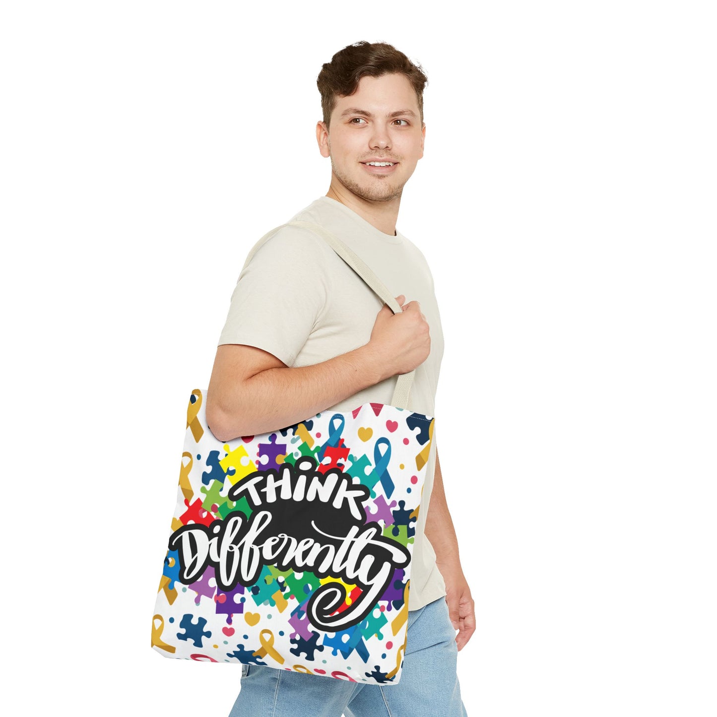 Colorful puzzle ribbon design on Think Differently Autism Awareness tote bag by Printify, showcasing vibrant AOP pattern.