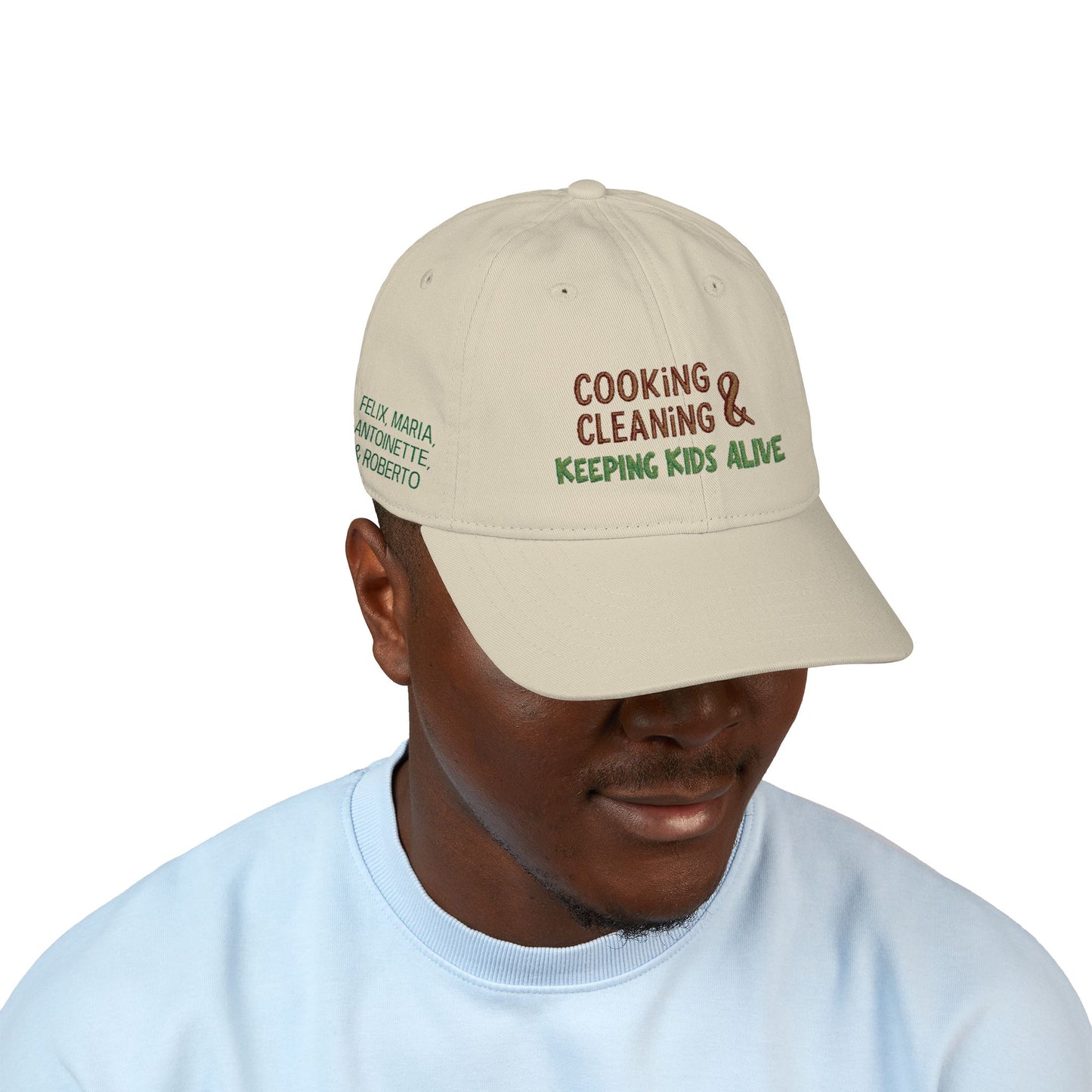 Organic baseball cap with embroidered "cooking, cleaning & keeping kids alive" text, featuring a casual hat design by Printify.