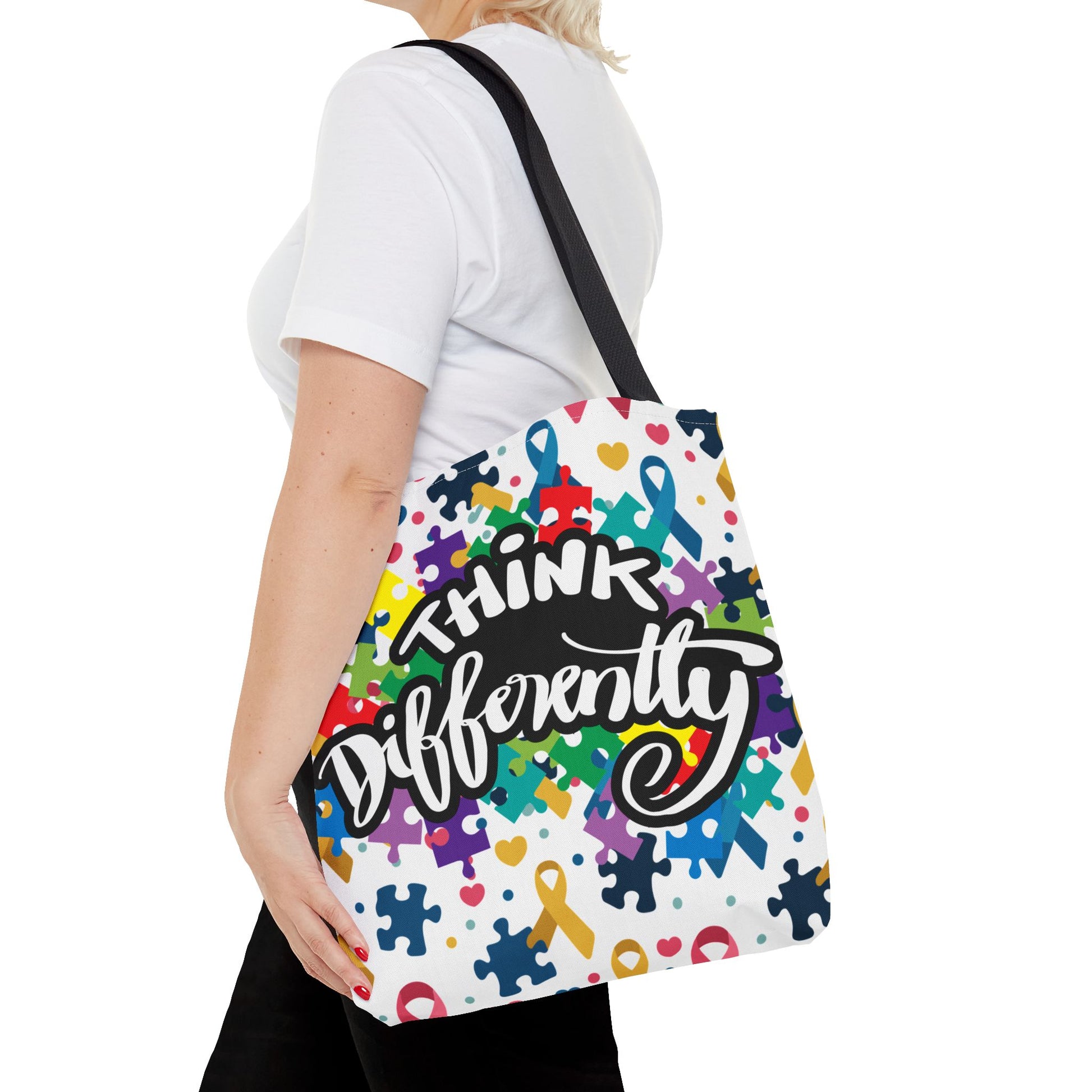 Colorful puzzle ribbon design on Think Differently Autism Awareness Tote Bag by Printify, showcasing vibrant colors and patterns.