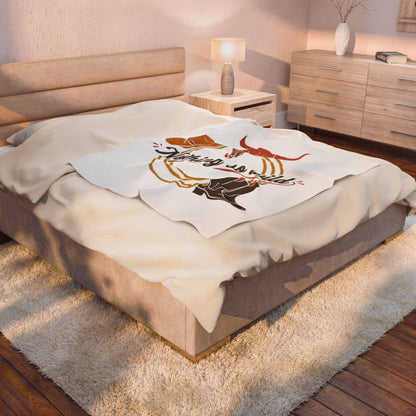 Velveteen plush blanket with cowboy chic western desert print by Printify, featuring all-over southwestern-inspired patterns.
