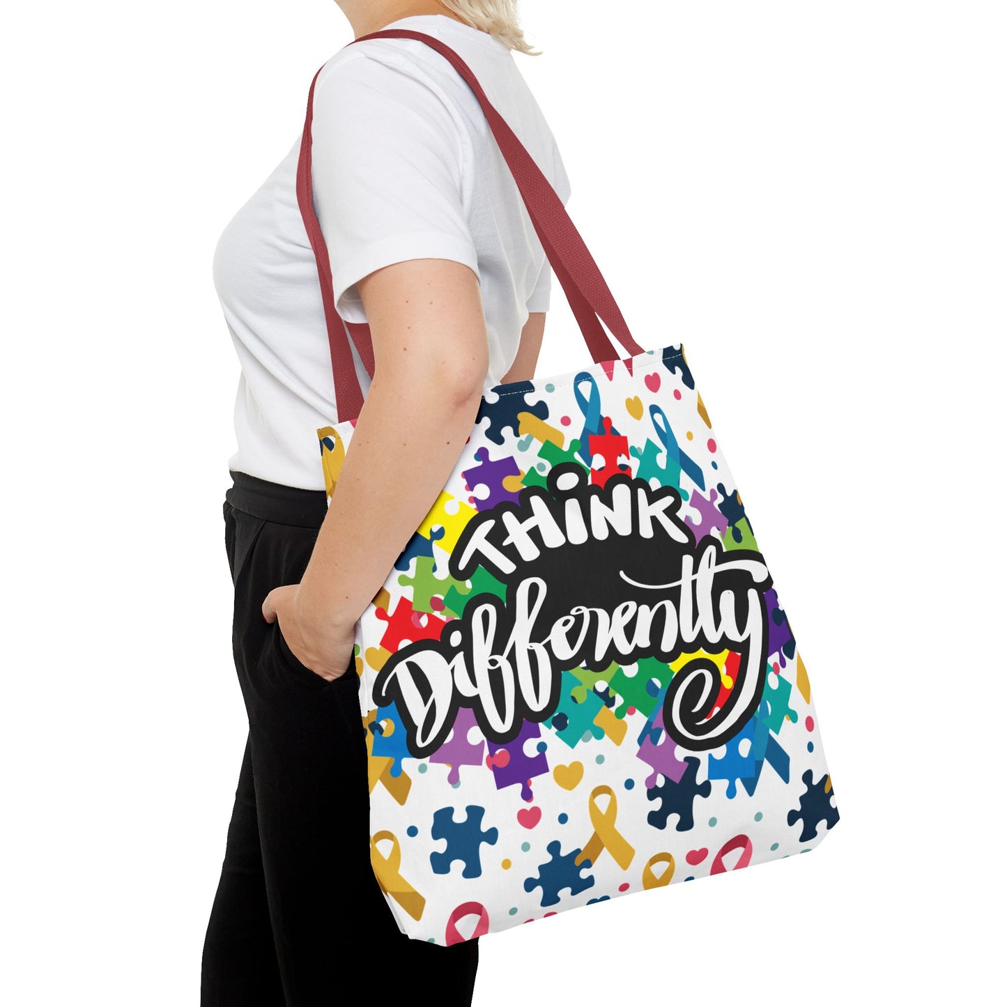 Colorful puzzle ribbon design on Think Differently Autism Awareness tote bag by Printify, showcasing vibrant artwork.