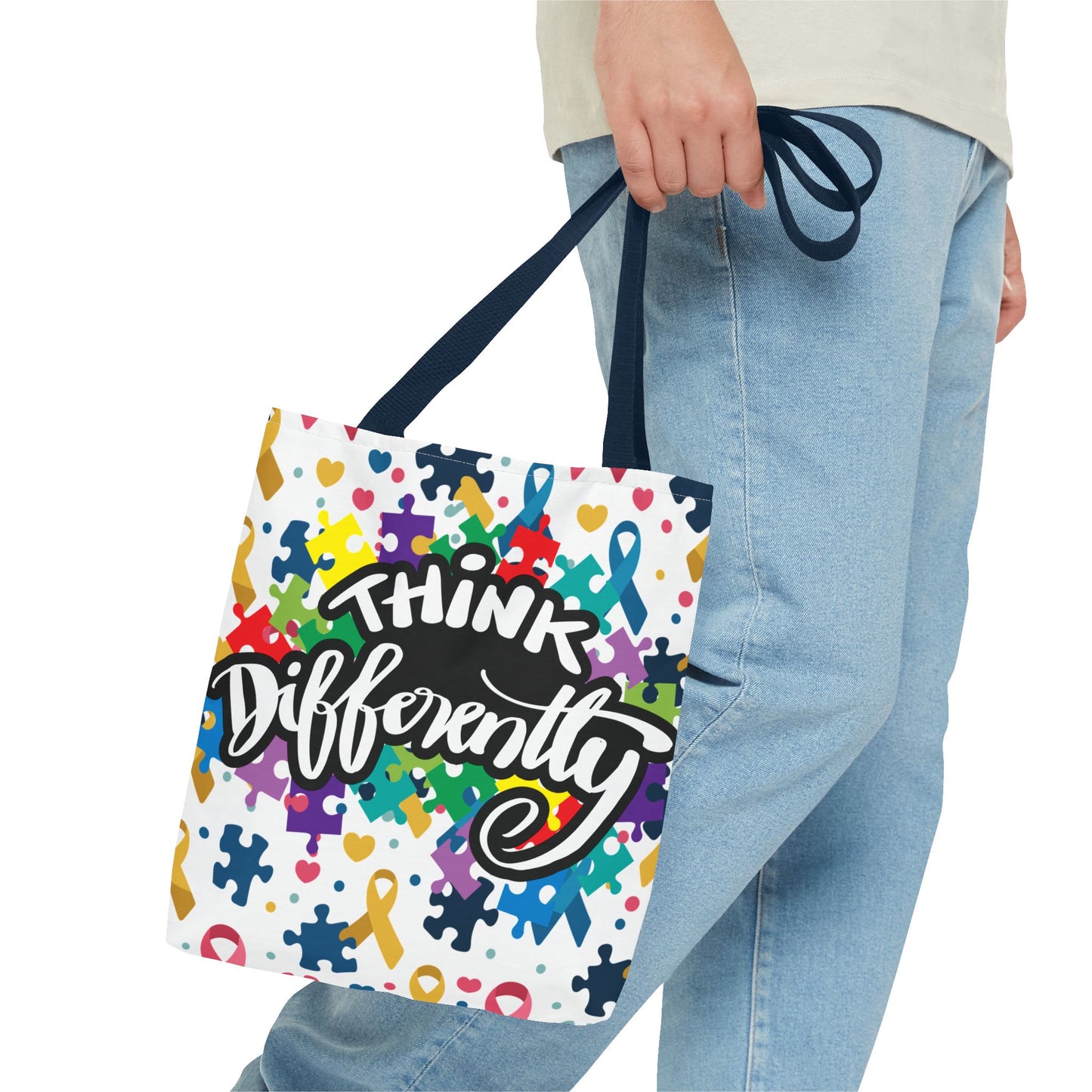 Colorful puzzle ribbon design on Think Differently Autism Awareness Tote Bag by Printify, showcasing vibrant artwork.