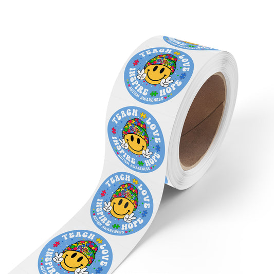 Autism awareness round sticker roll with "Teach Love Inspire Hope" message, smiley face, and puzzle piece design on paper labels.