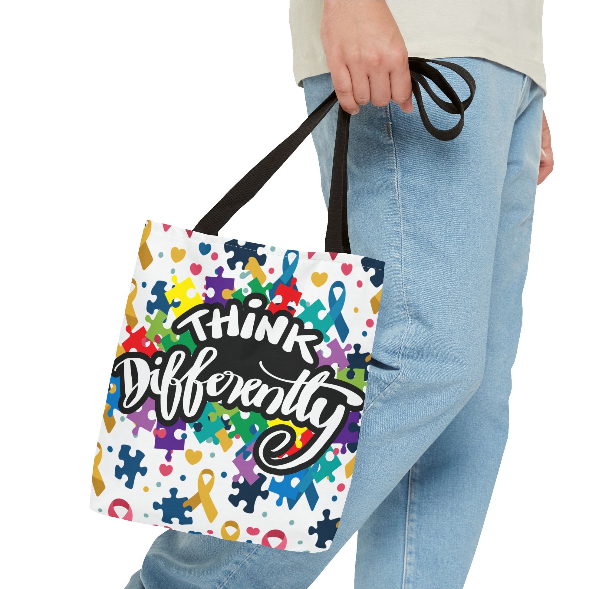 Colorful puzzle ribbon design on Think Differently Autism Awareness Tote Bag by Printify, showcasing vibrant patterns.