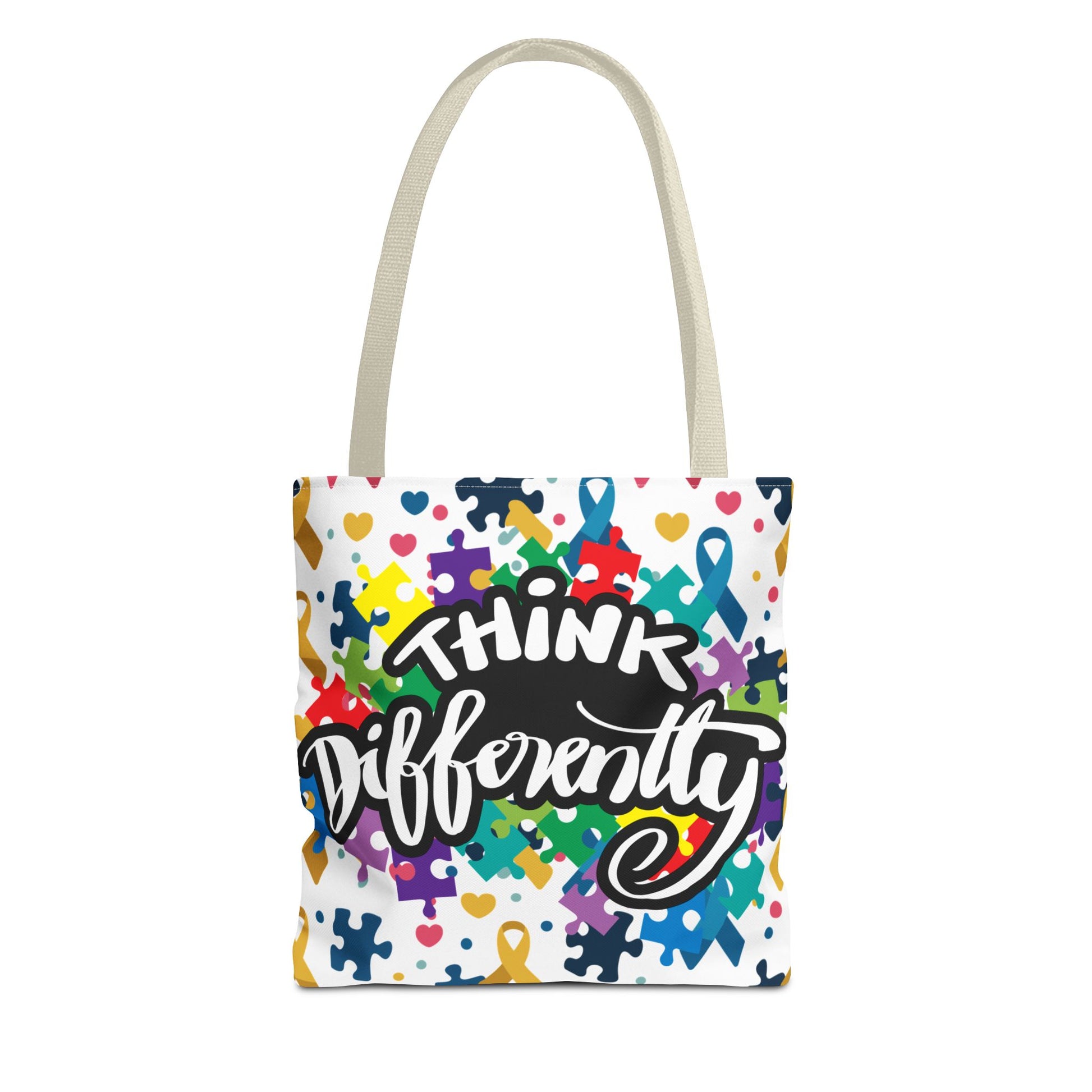 Colorful puzzle ribbon design on Think Differently Autism Awareness tote bag by Printify, showcasing vibrant patterns.