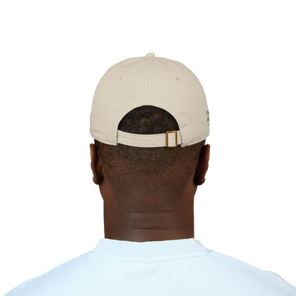 Organic baseball cap with custom embroidered name and humorous "cooking, cleaning & keeping kids alive" slogan, made by Printify.