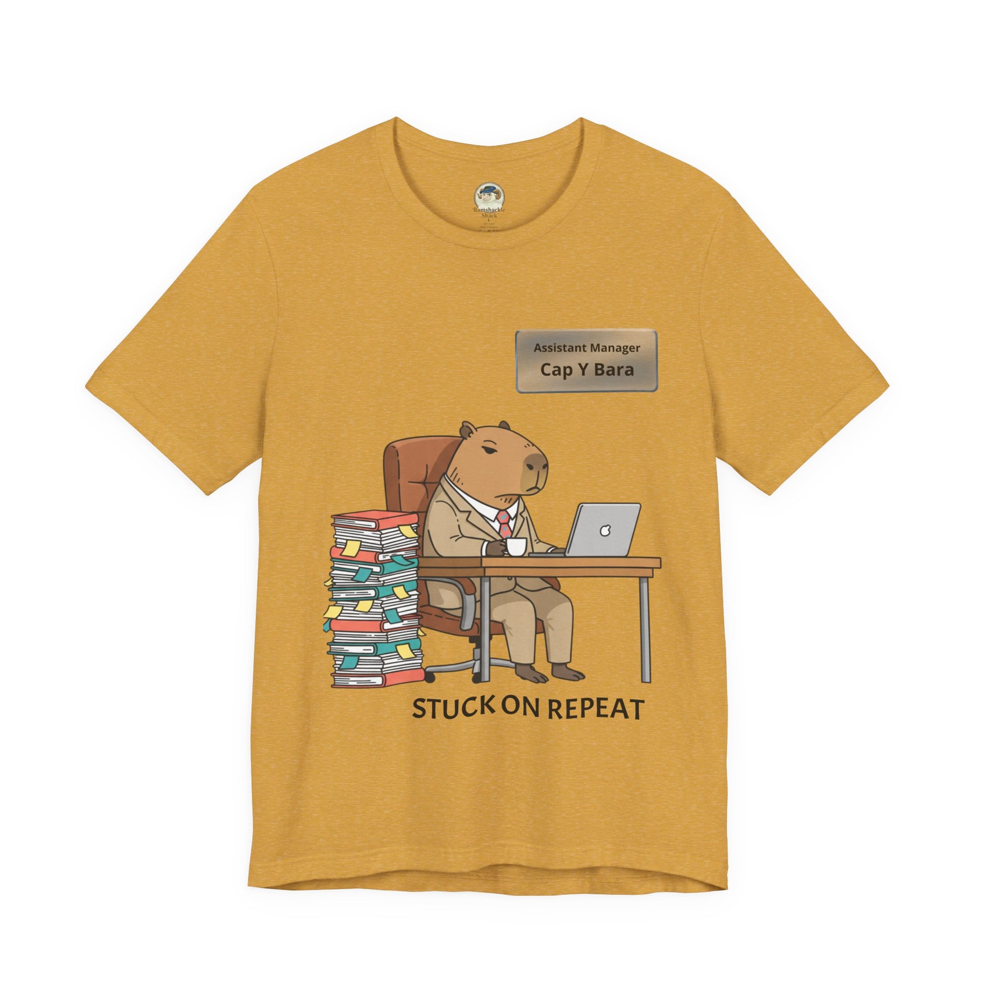 Capybara in suit desk tee with "Stuck on Repeat" personalized nameplate graphic on a casual T-shirt, front view.