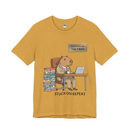 Capybara in suit desk tee with "Stuck on Repeat" personalized nameplate graphic on a casual T-shirt, front view.