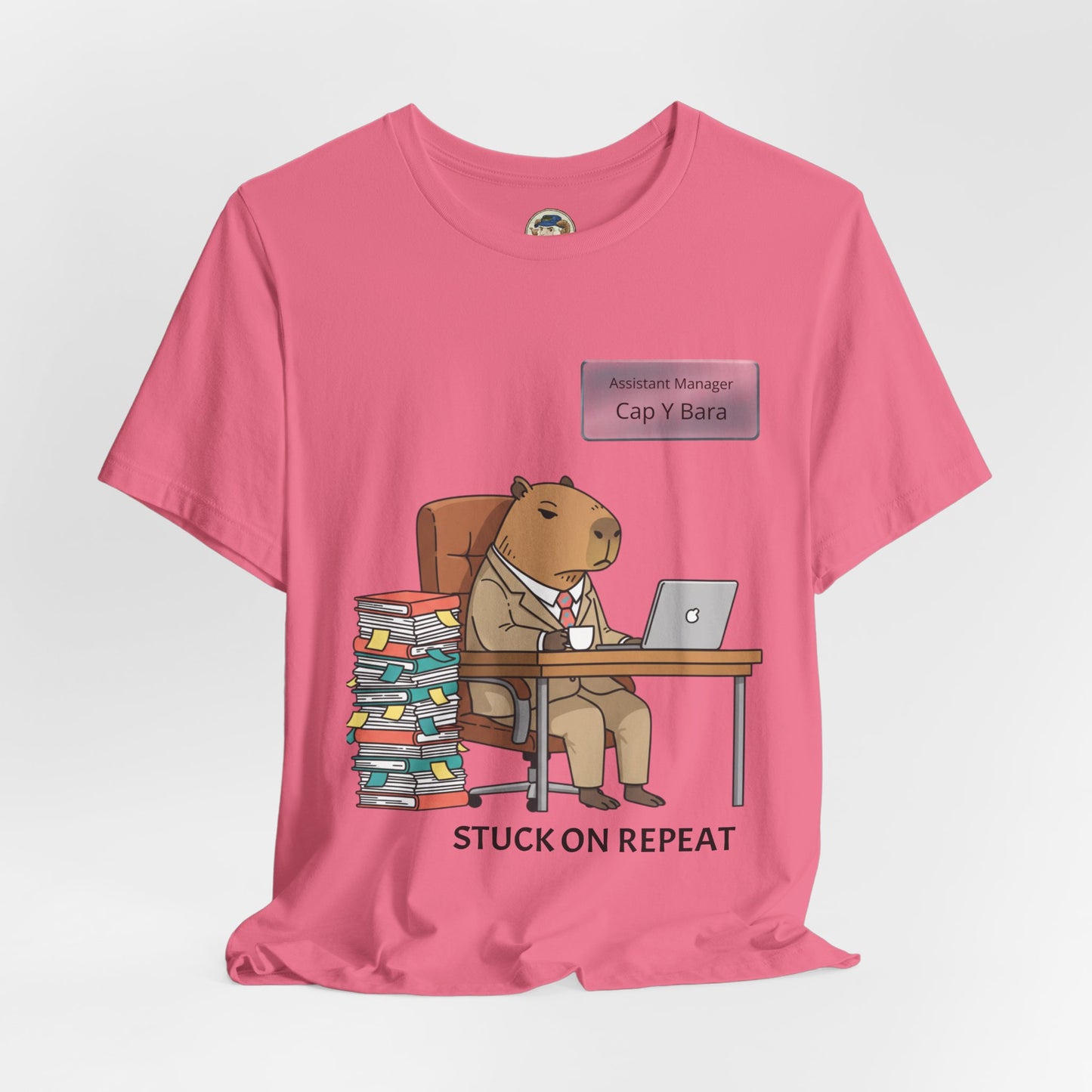 Capybara in suit graphic T-shirt with "Stuck on Repeat" phrase and personalized nameplate design, casual Printify tee for animal lovers.