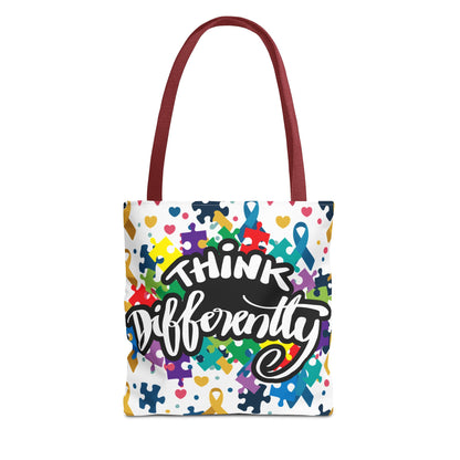 Colorful puzzle ribbon design on Think Differently Autism Awareness tote bag by Printify, showcasing vibrant patterns.