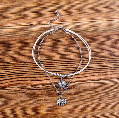 Vintage elephant anklet and bracelet set featuring intricate silver designs, perfect for boho style jewelry lovers.