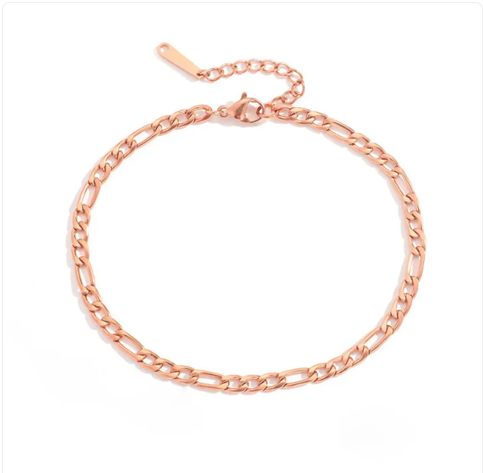 Stainless steel fashion anklet with intricate chain design, featuring a sleek and modern look, worn on a person's ankle.