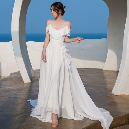 Elegant women's white chiffon dress by Ramshackle Shack, flowing fabric and delicate design perfect for formal occasions.